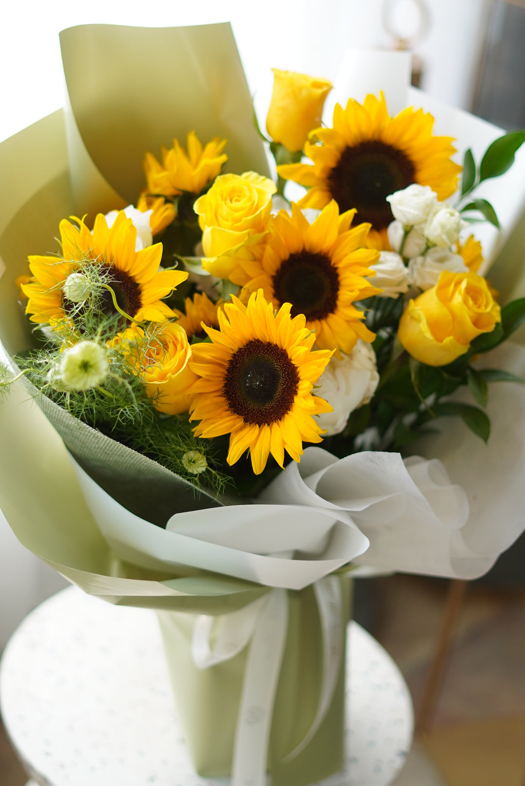 Sunflowers Bouquet from Moon's Flowers featuring fresh yellow sunflowers, roses, and green filler blooms in a premium hand-tied wrap.