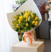 Vibrant yellow and white tulip bouquet wrapped in elegant paper — same day flower delivery Toronto