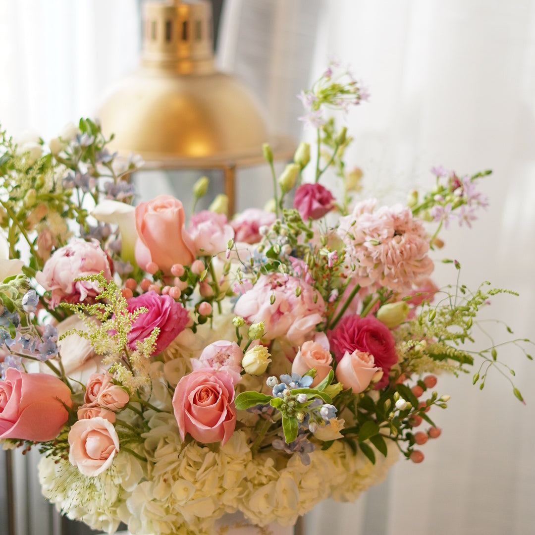 a garden-style centerpiece featuring soft pink roses, wax flowers in a premium giftbox, perfect for Mother's Day table decor