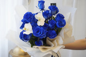  blue rose bouquet with white orchid and natural greenery
