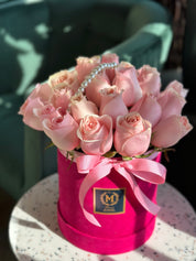 Romantic Blush roses adorned with delicate pearl string accessory in a hot pink hat box with bow by Moons flowers /fresh flowers delivery in Toronto