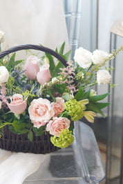 garden style floral basket arrangement with mixed textures and soft colors