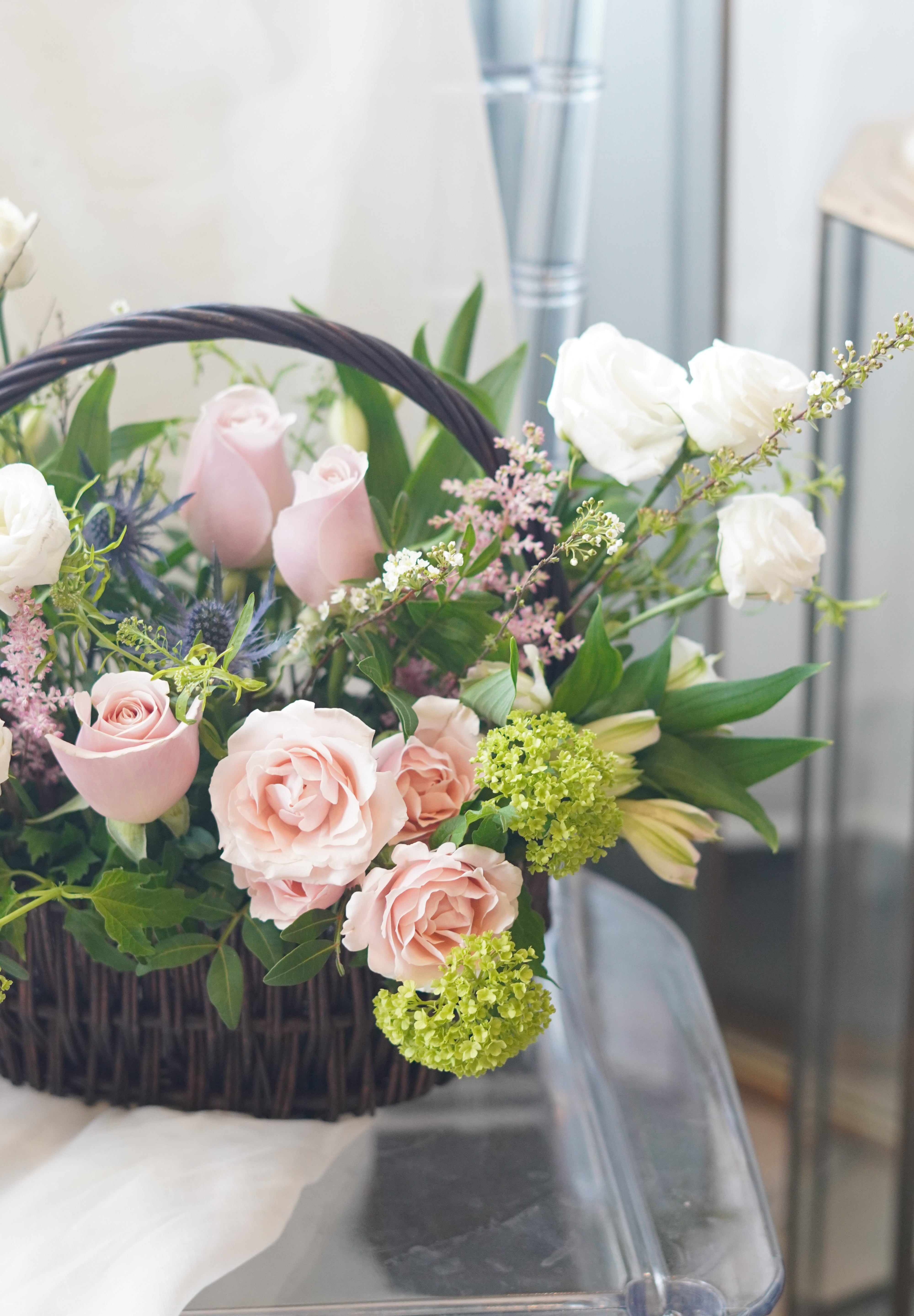 garden style floral basket arrangement with mixed textures and soft colors