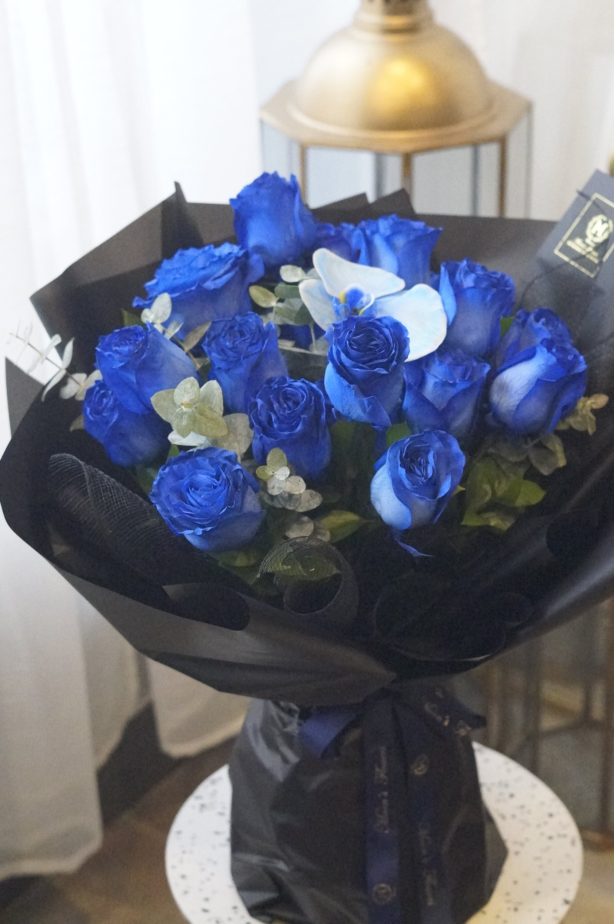 2 dozen blue roses with blue orchid