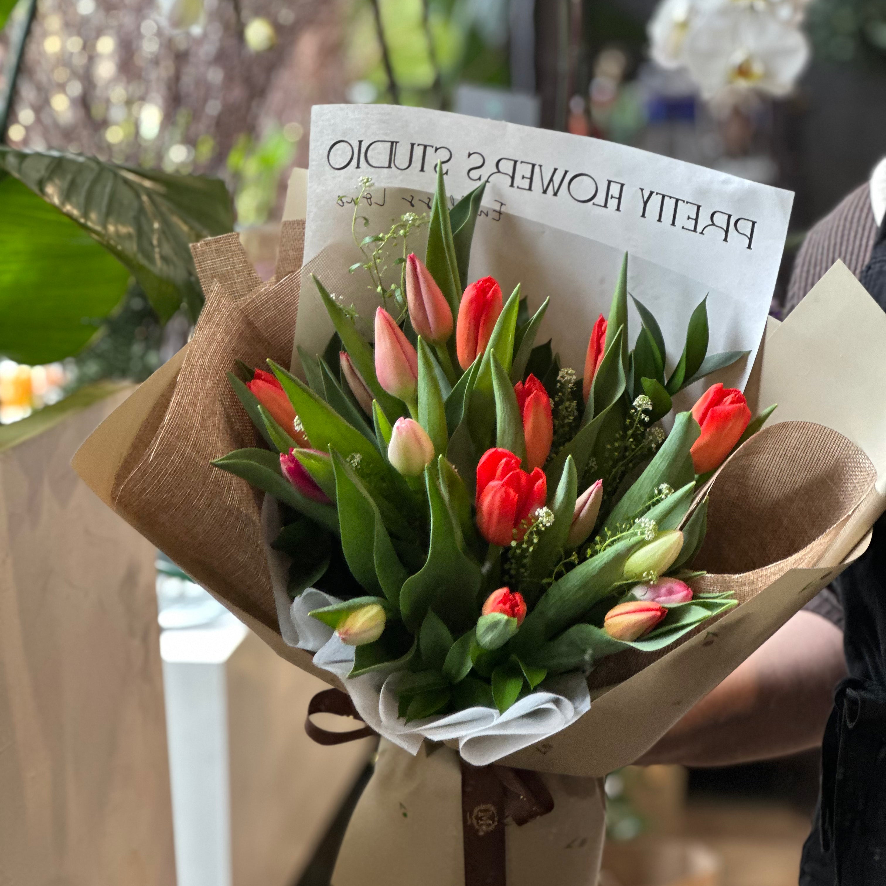 Colorful Mother's Day tulip bouquet with mixed fresh tulips in elegant designer wrapping by Moon's Flowers Toronto.