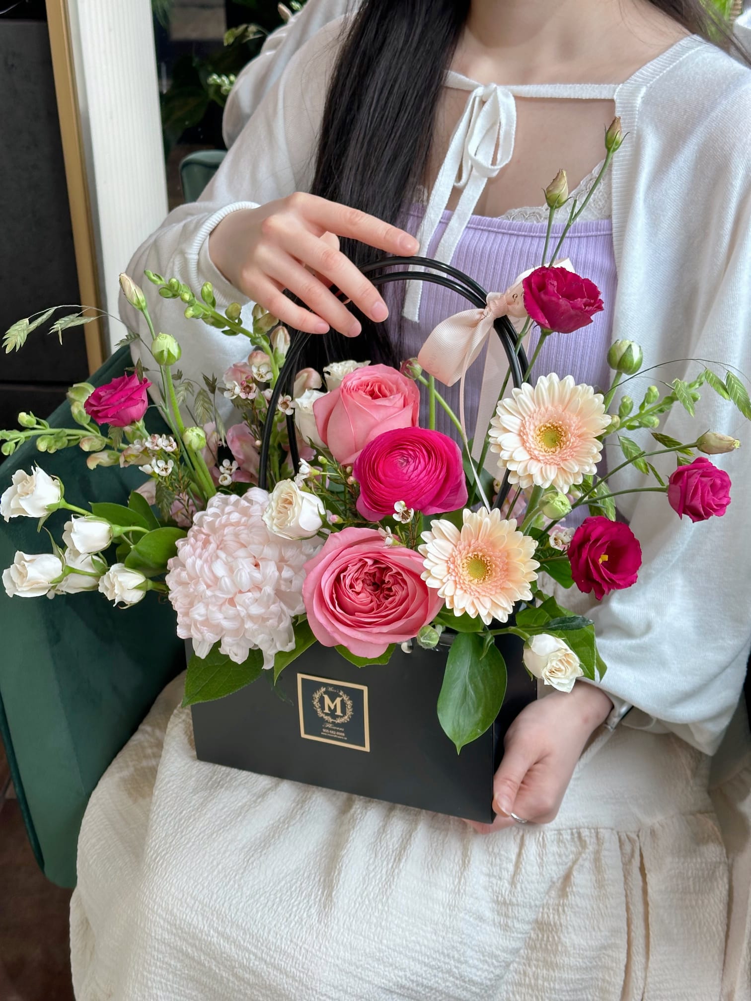 Signature Moon's Flowers luxury floral tote. Artfully arranged with a blush pink chrysanthemum, premium roses, and fresh greenery.