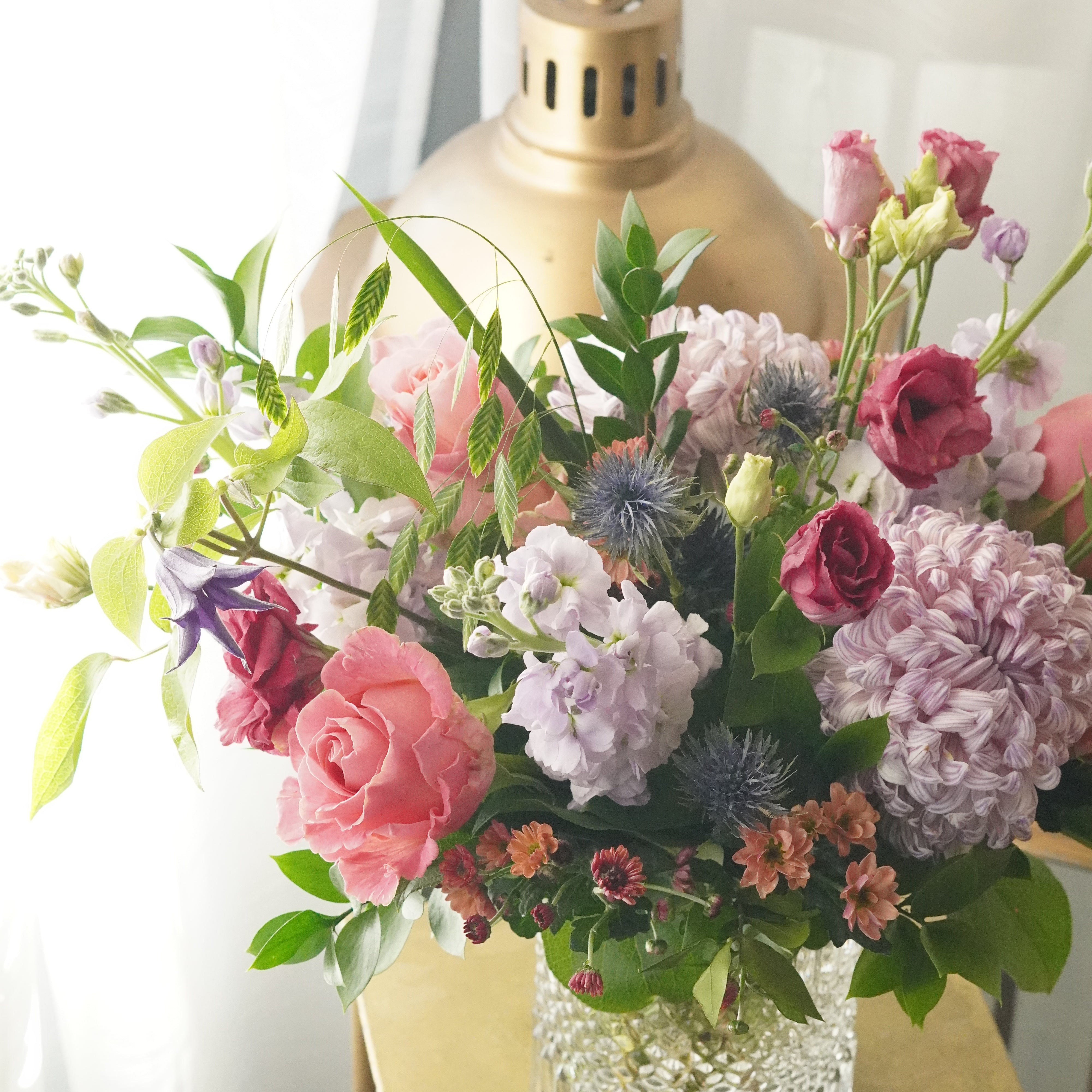 natural garden style flower arrangement in glass vase