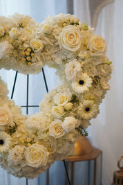 Large white floral heart wreath featuring white roses and greenery, handcrafted by Moon's Flowers Toronto.