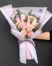 Heart-shaped pink rose bouquet styled for a romantic floral gift