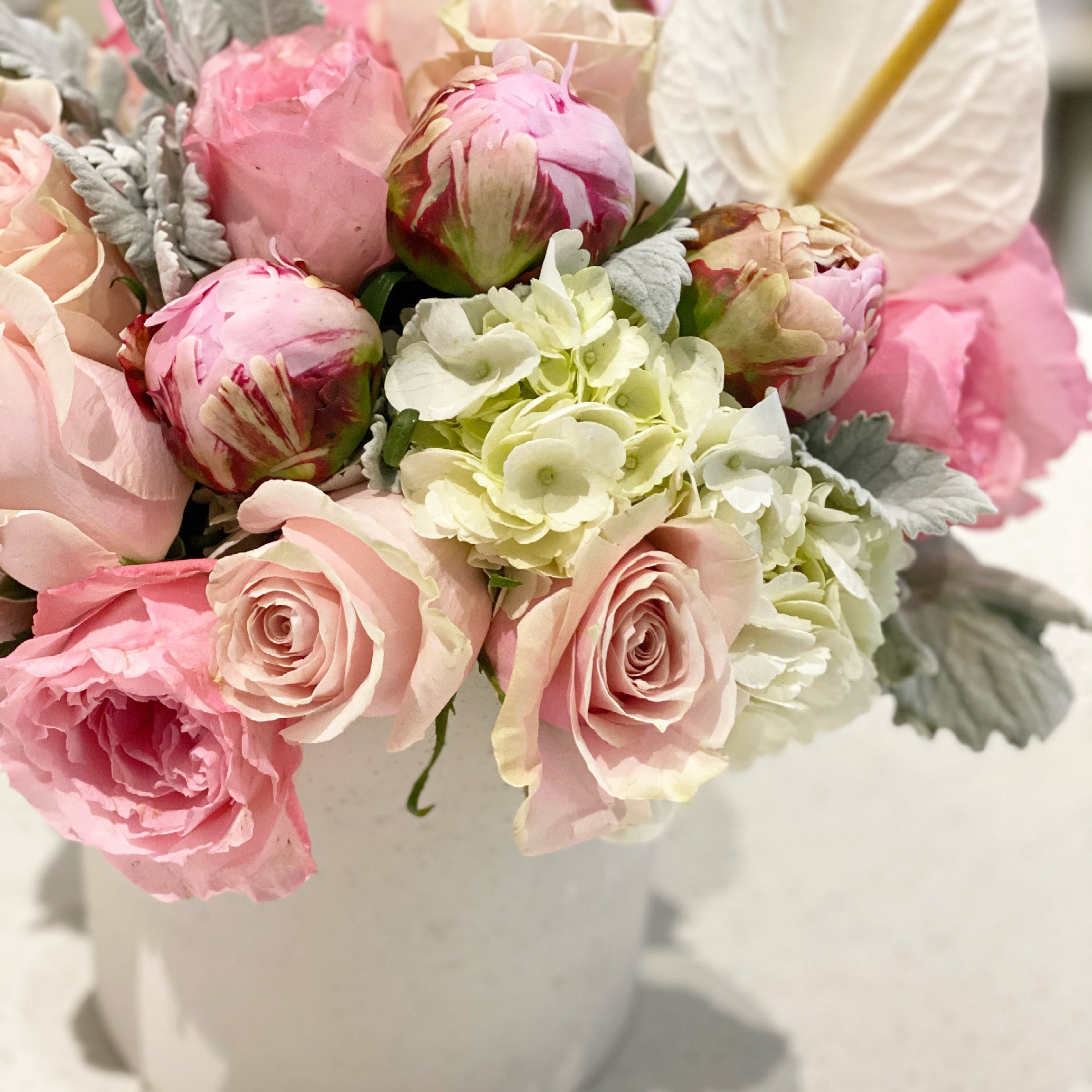 Premium soft pink flower arrangement with peonies and roses
