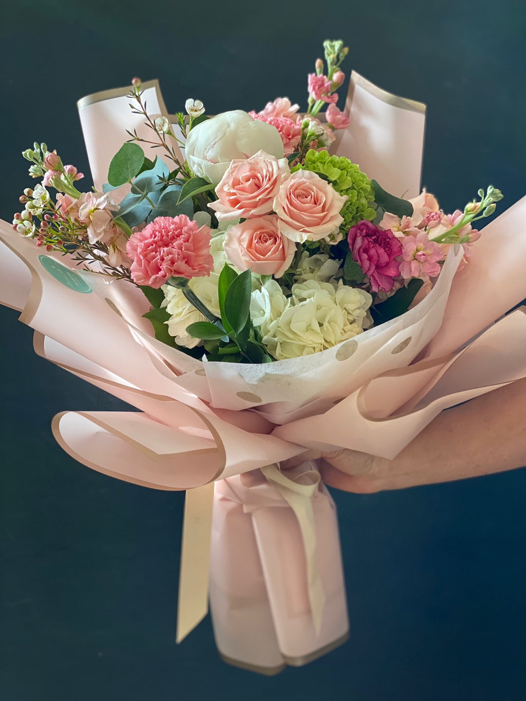 Deluxe size blush pink rose and white hydrangea bouquet wrapped in soft pink paper